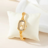 Helena® - Elegant Gold Watch Featuring an Oval Dial and Sleek Black Frame